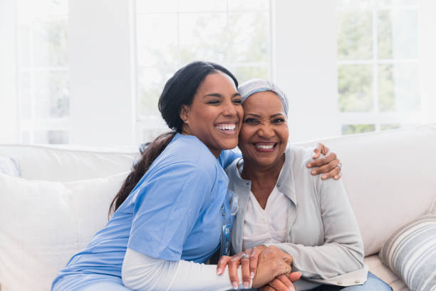 The elderly woman enjoys an embrace from her favorite home healthcare nurse.